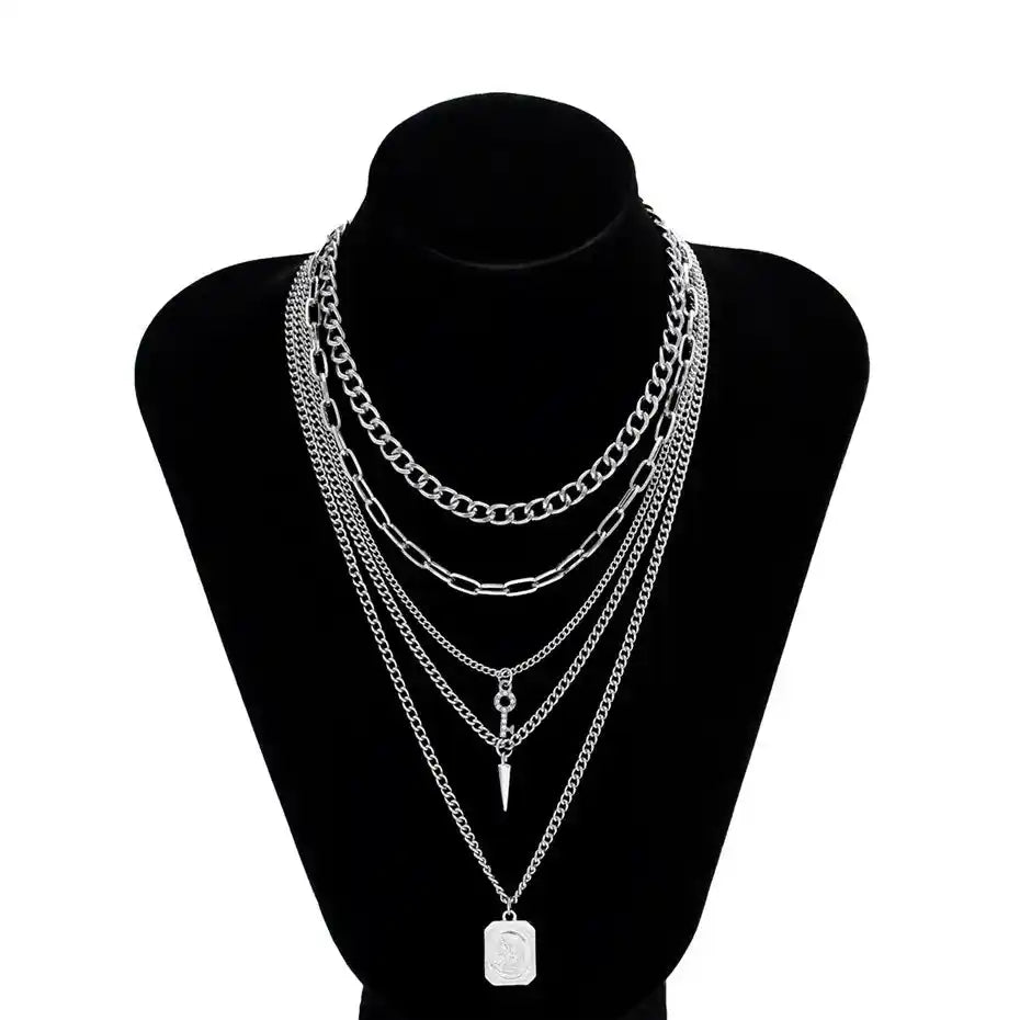 Layered silver chain necklaces on black display bust