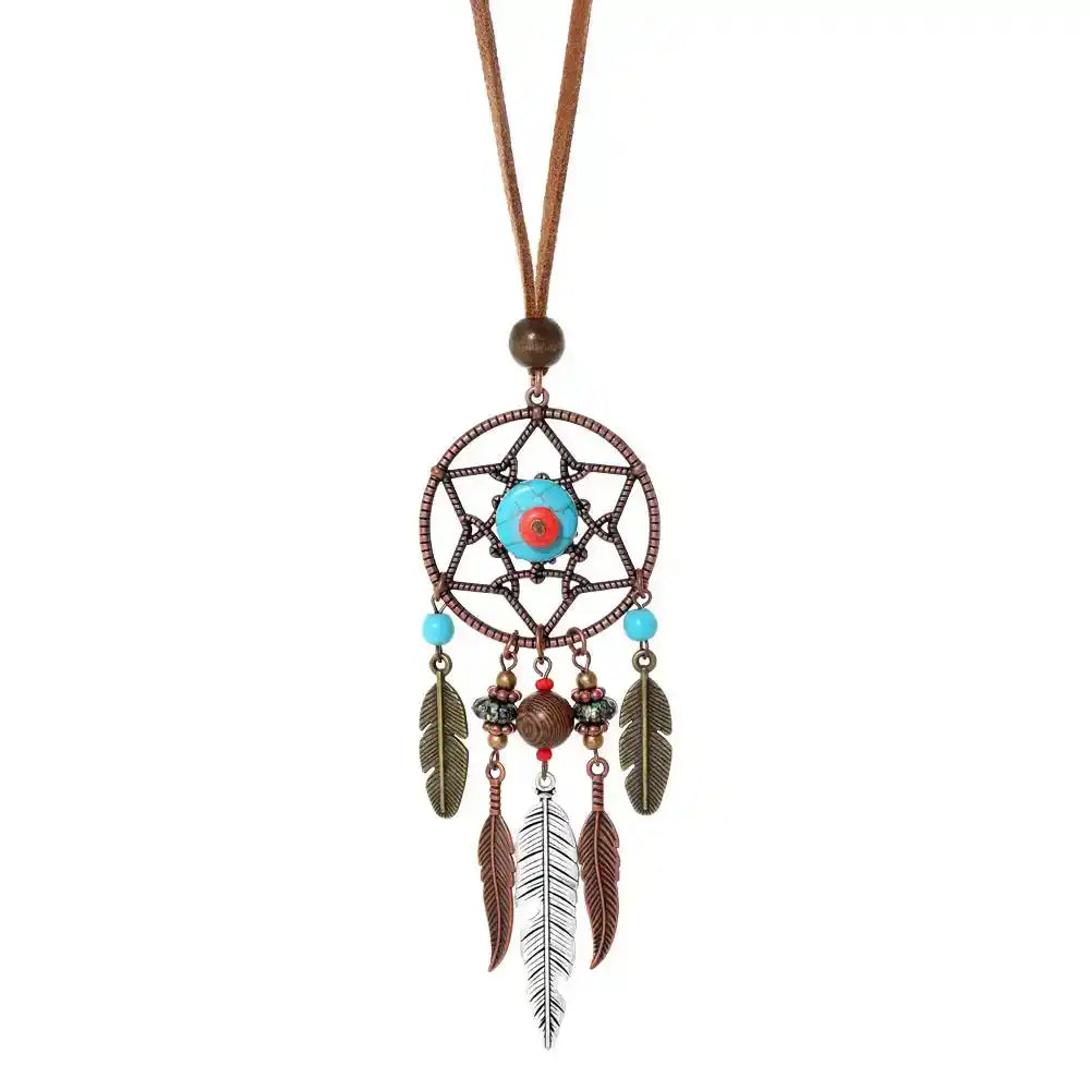 Long bohemian feather pendant necklace with turquoise & ethnic metalwork on a leather rope chain. Lightweight, durable, festival-ready. Ships from Pedlar's Attic.