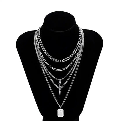 Layered silver chain necklaces on black display bust
