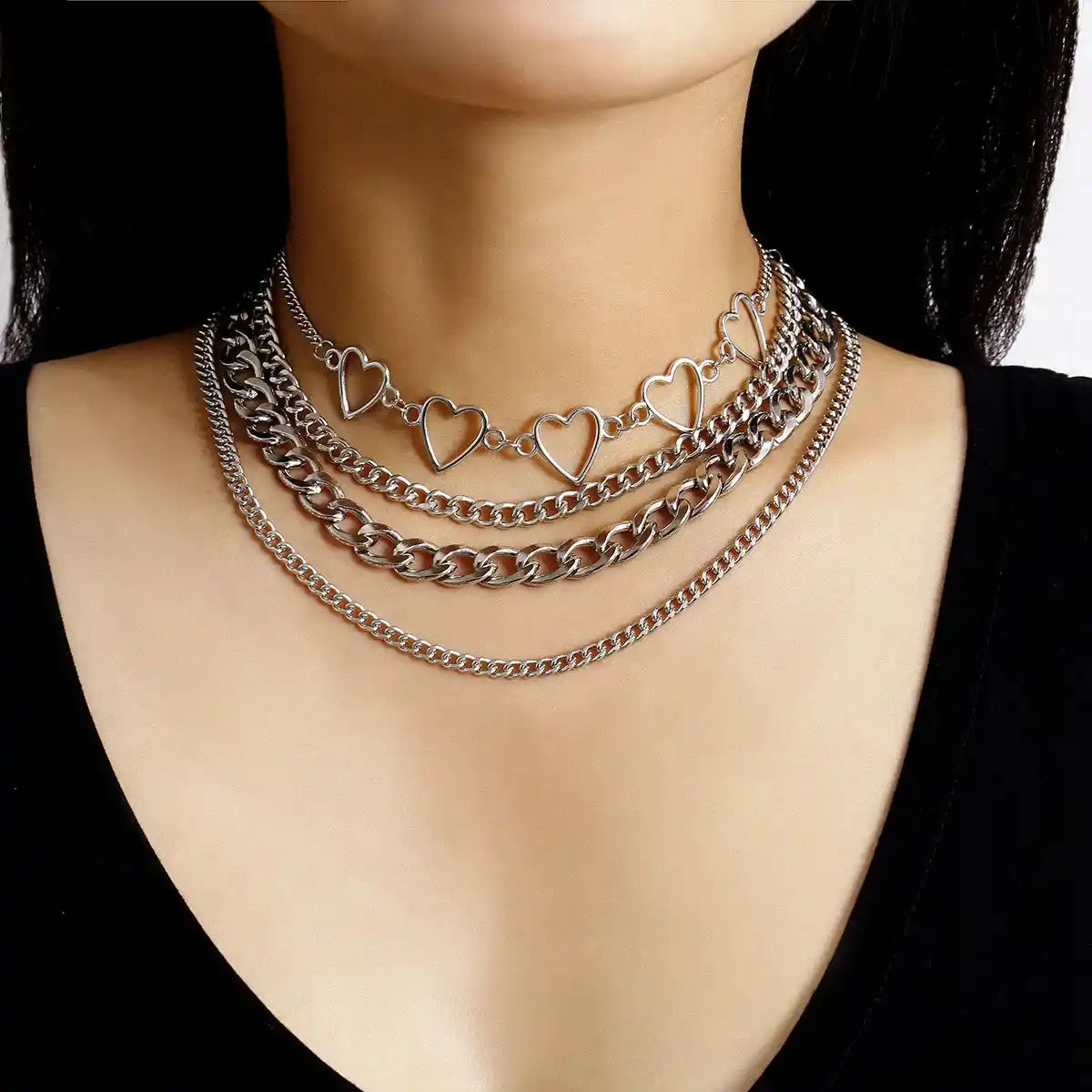 Silver layered chain necklaces with heart, spike, and portrait pendants, goth jewelry