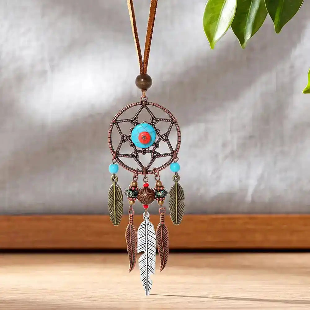 Long bohemian feather pendant necklace with turquoise & ethnic metalwork on a leather rope chain. Lightweight, durable, festival-ready. Ships from Pedlar's Attic.