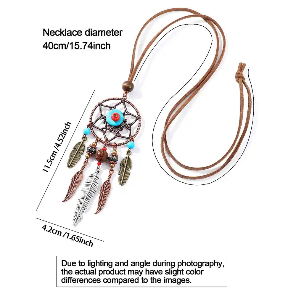 Long bohemian feather pendant necklace with turquoise & ethnic metalwork on a leather rope chain. Lightweight, durable, festival-ready. Ships from Pedlar's Attic.