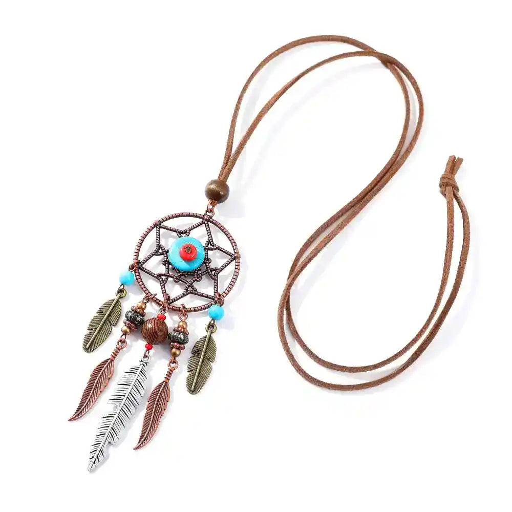 Long bohemian feather pendant necklace with turquoise & ethnic metalwork on a leather rope chain. Lightweight, durable, festival-ready. Ships from Pedlar's Attic.