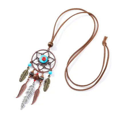 Long bohemian feather pendant necklace with turquoise & ethnic metalwork on a leather rope chain. Lightweight, durable, festival-ready. Ships from Pedlar's Attic.